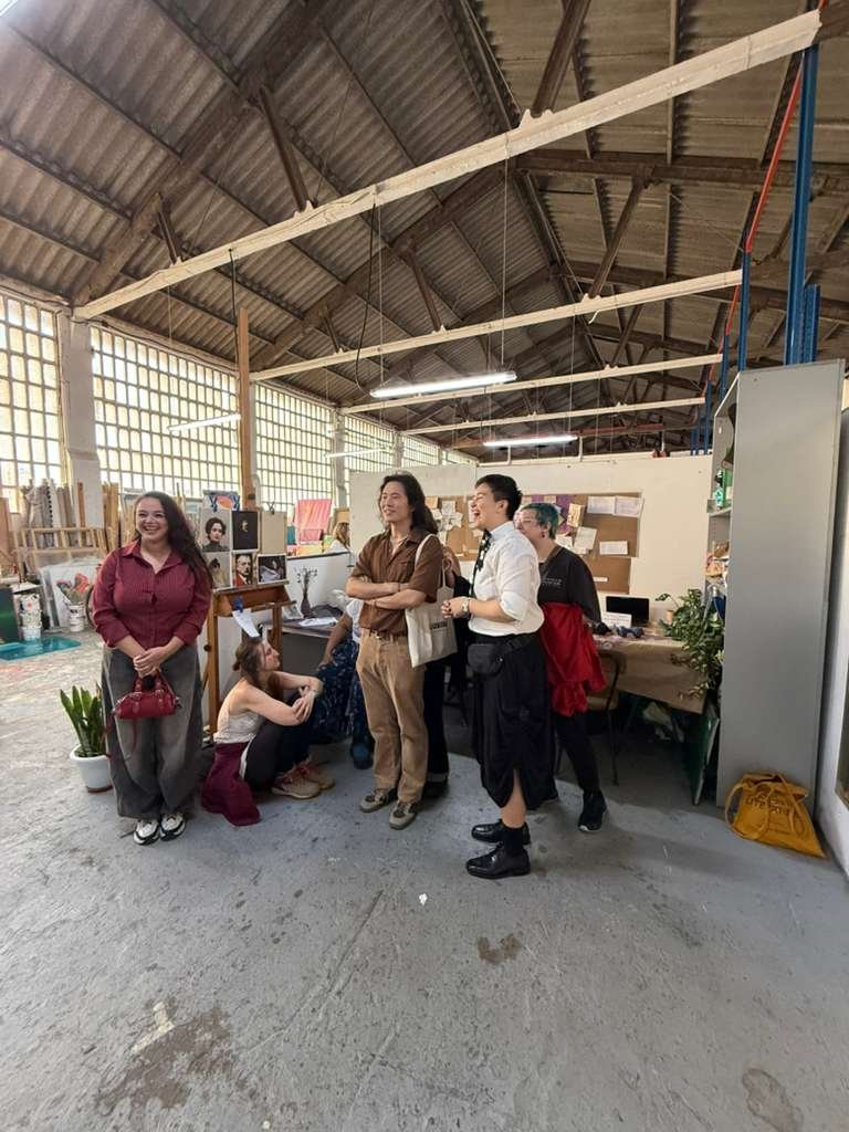 Art enthusiasts viewing figurative oil paintings at Barcelona open studio exhibition