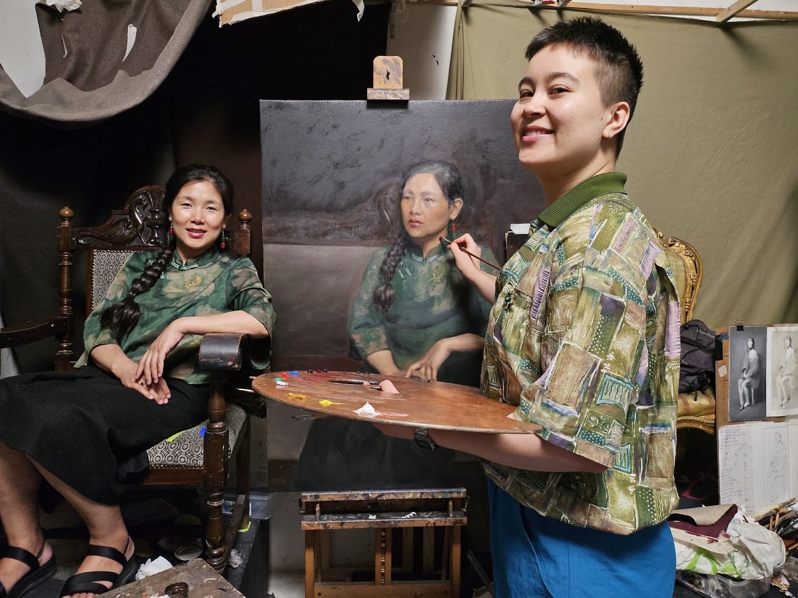 T. painting with Jie seated as model, the canvas behind in an advanced state of refinement